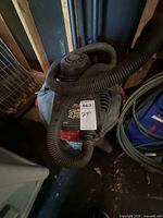 Top view of Hoover wet/dry vacuum with hose attached