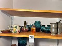 Shelf with assortment of vases, pitcher, dish, goblets