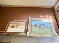 Both framed artworks side by side on surface