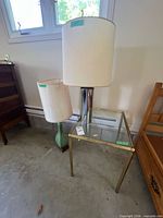 Both lamps and glass-top table in situ