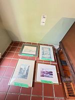 All four framed prints on tile floor