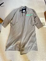 Full view of taupe overcoat laid flat