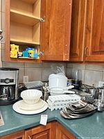 Overall lot on countertop showing coffee maker, bowls, trays, canisters, NutriBullet