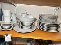 Overall lot showing stacked plates, cups and serving pieces