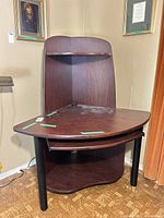 Corner computer desk showing shape, finish, keyboard tray and shelf