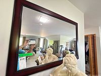Front view of mirror on wall showing full frame and reflection
