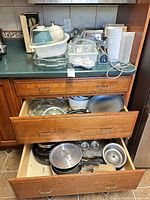 Overview of countertop stack and open drawers showing cookware variety