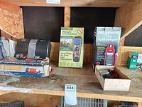 Shelf with ThermaCELL repellent, MotoMaster jack, foot pump box, black inflator, small fasteners box