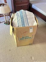 Box labeled linens showing packed fabrics