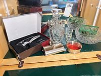 Group view of decanter, corkscrew set, bowls, shot glasses, silver items