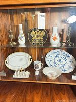 Full cabinet view showing all porcelain and brass items