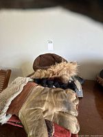 Pile showing fur-trim hat, collar and assorted gloves