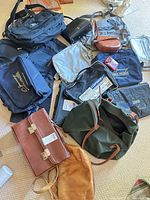 Overall pile of assorted bags showing variety, materials and branding