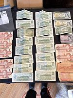 Full layout of all Canadian and US banknotes on tabletop