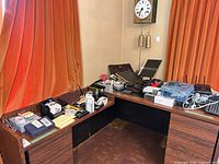 Overall view of desks with assorted electronics, printer not visible