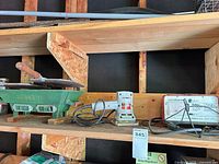 Shelf with hibachi grill, sander, battery charger