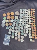 Full layout of mixed copper and nickel coins on black fabric