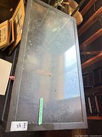 Top view of rectangular glass tabletop within metal frame