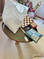 Tray table with chess board, pillow, boxes and bag on top