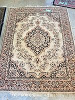 Full view of rug showing pattern, colors and fringe