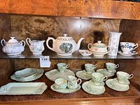 Full view of cabinet shelves showing all tea and serving pieces