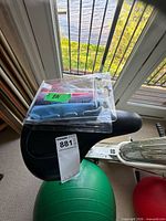Black bike saddle with packaged resistance bands on top