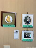 All three framed pieces on wall with size notes visible