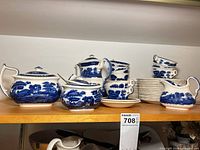 Full view of Spode blue transferware service pieces and stacked plates