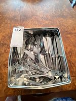 Tray containing assorted stainless flatware pieces