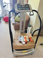 Full view of T-Zone VT-15 vibration plate with boxed platform, manuals and dumbbells on base
