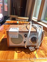 Front view of Tivoli Audio Model One radio with power cord wrapped
