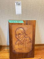 Full view of tooled leather panel mounted on wood
