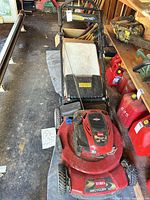 Full mower with bag attached, red deck, black handle