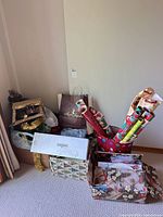 Overall lot showing wrapping paper rolls, bags, boxes, tinsel and storage boxes