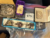 Assorted jewelry pieces in boxes and bag