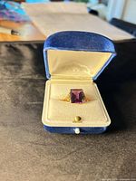 Ring in open blue box, frontal view