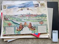Stack with cityscape map print on top showing general lot contents