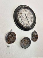 Wall clock and three owl plaques on wall