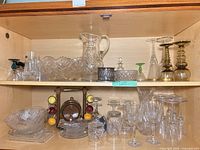 Cabinet showing pitcher, bowls, stemware, wooden barrel set, crystal pieces