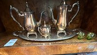 Full view of five-piece silver-plated tea and coffee service on tray