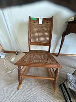 Front view of wooden chair showing cane back and seat