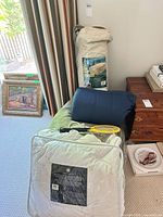 Group shot of sleeping bag, air mattress, comforter, duvet cover, pillow, throw blanket, bug zapper