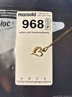 Lot overview with pendant and chain beside inventory card