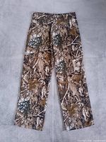 Full front view of camouflage cargo pants laid flat
