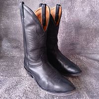 Full view of both black leather cowboy boots angled right