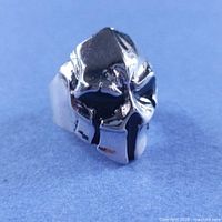 Front view of silver skull armored mask ring
