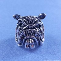 Front view showing snarling bulldog face and detailing