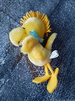 Full view of yellow Woodstock plush showing overall appearance