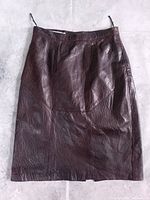 Front view of brown leather skirt showing panel construction and overall condition
