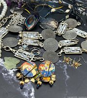Assorted jewelry and belt laid out showing variety of items